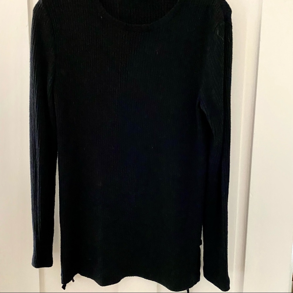 Black tunic with fancy ties. narrow with stretch. 17” chest 18 1/2” under arm